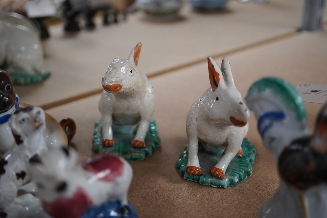 A collection of 19th/20th century Staffordshire and continental porcelain models of animals and birds, including a 20th century Meissen figure of a canary, two Continental porcelain Panthers, two similar recumbent dogs,